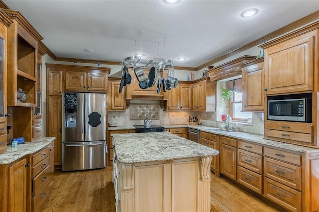 2621 SE 5th St, Lees Summit, MO 64063 - kitchen featuring appliances with stainless steel finishes, crown molding, light wood-style flooring, light stone counters, and recessed lighting