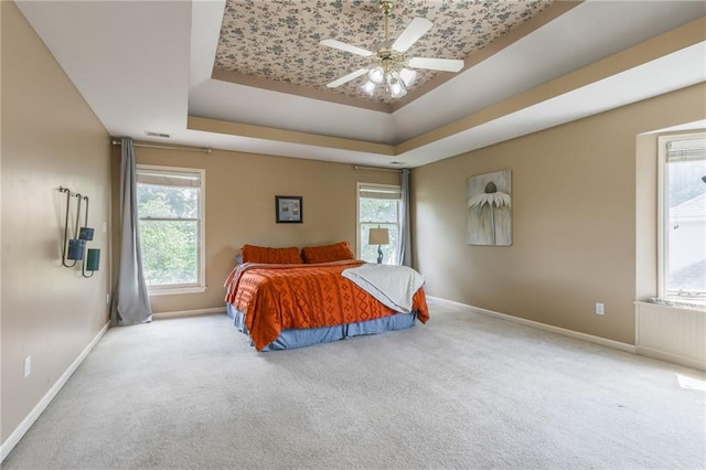 2621 SE 5th St, Lees Summit, MO 64063 - bedroom featuring a tray ceiling, carpet, and multiple windows