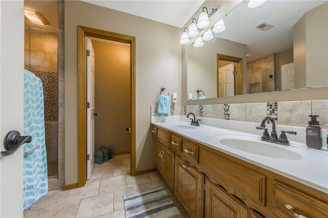 2621 SE 5th St, Lees Summit, MO 64063 - full bathroom featuring a stall shower, double vanity, tile patterned floors, and tasteful backsplash