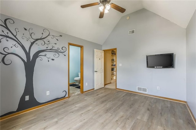 2621 SE 5th St, Lees Summit, MO 64063 - unfurnished bedroom with ensuite bathroom, wood finished floors, high vaulted ceiling, and a ceiling fan