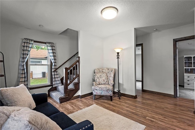 314 E Nichols St, Spring Hill, KS 66083 - living room with wood finished floors, a textured ceiling, and stairs