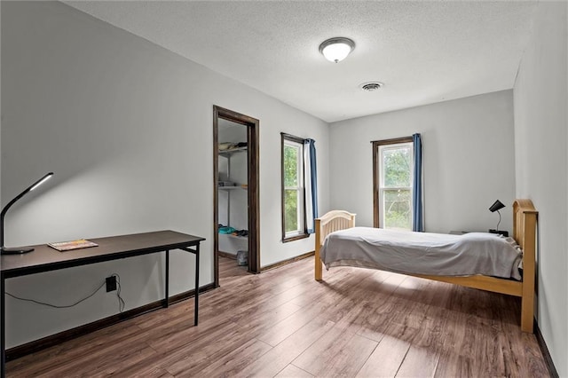 314 E Nichols St, Spring Hill, KS 66083 - bedroom featuring wood finished floors and a textured ceiling