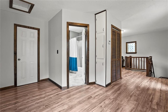 314 E Nichols St, Spring Hill, KS 66083 - hall featuring light wood-style flooring and an upstairs landing