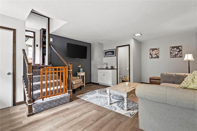 314 E Nichols St, Spring Hill, KS 66083 - living area with a textured ceiling, wood finished floors, and stairway