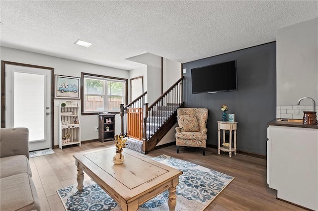 314 E Nichols St, Spring Hill, KS 66083 - living room featuring wood finished floors, a textured ceiling, and stairway