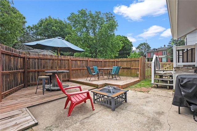 314 E Nichols St, Spring Hill, KS 66083 - fenced backyard featuring a fire pit, a wooden deck, and a patio area