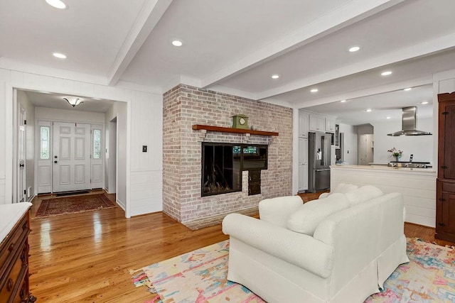 9201 Ensley Ln, Leawood, KS 66206 - living area featuring light wood-type flooring, beam ceiling, and a fireplace
