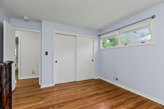 9201 Ensley Ln, Leawood, KS 66206 - unfurnished bedroom featuring wood finished floors and a closet