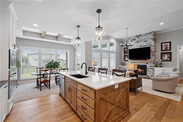 9260 Saddletop St, Lenexa, KS 66227 - kitchen with stainless steel appliances, light wood finished floors, a stone fireplace, plenty of natural light, and recessed lighting