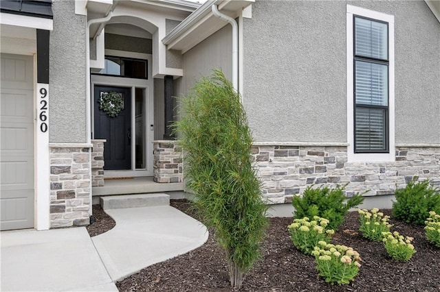 9260 Saddletop St, Lenexa, KS 66227 - view of exterior entry with stone siding and stucco siding