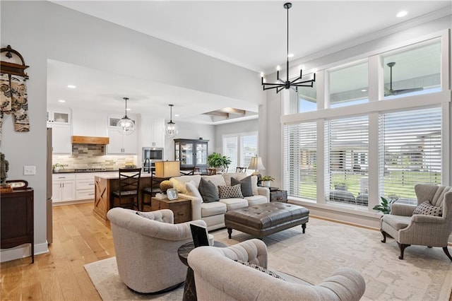 9260 Saddletop St, Lenexa, KS 66227 - living area with a chandelier, ornamental molding, recessed lighting, and light wood finished floors