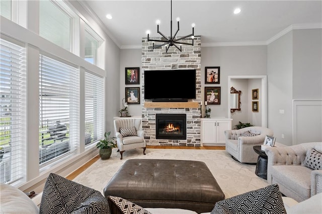 9260 Saddletop St, Lenexa, KS 66227 - living room with crown molding, a chandelier, healthy amount of natural light, light wood-style flooring, and a stone fireplace