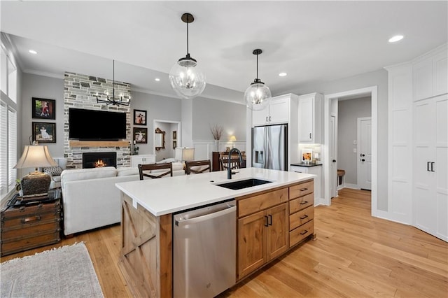 9260 Saddletop St, Lenexa, KS 66227 - kitchen featuring stainless steel appliances, open floor plan, a fireplace, crown molding, and recessed lighting