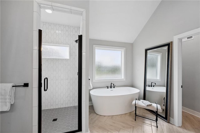9260 Saddletop St, Lenexa, KS 66227 - bathroom with a shower stall, a freestanding tub, and vaulted ceiling