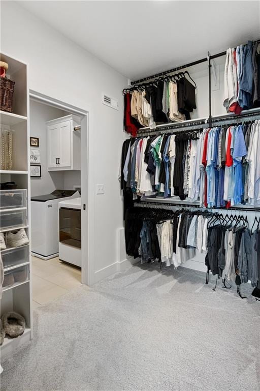 9260 Saddletop St, Lenexa, KS 66227 - spacious closet featuring light colored carpet, washer and dryer, and light tile patterned floors