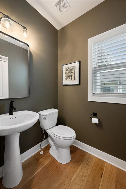 9260 Saddletop St, Lenexa, KS 66227 - half bathroom with baseboards and wood finished floors