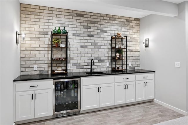 9260 Saddletop St, Lenexa, KS 66227 - indoor wet bar featuring beverage cooler, light wood-style flooring, and tasteful backsplash