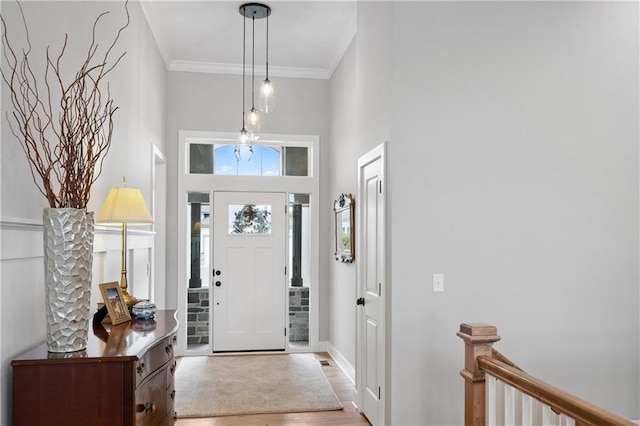 9260 Saddletop St, Lenexa, KS 66227 - entryway featuring wood finished floors, ornamental molding, and a towering ceiling