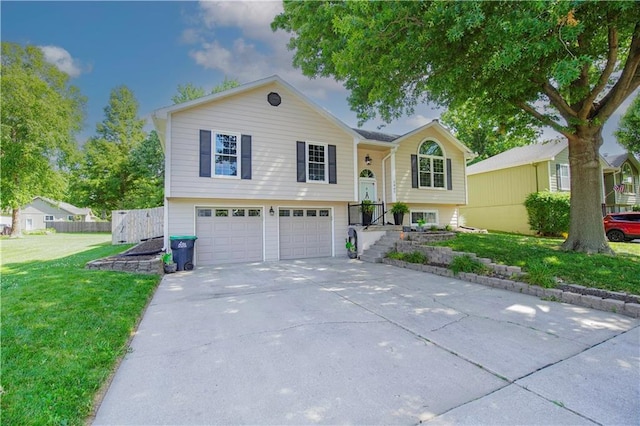 1005 Hunters Rd, Blue Springs, MO 64014 - bi-level home featuring concrete driveway, an attached garage, and a front lawn