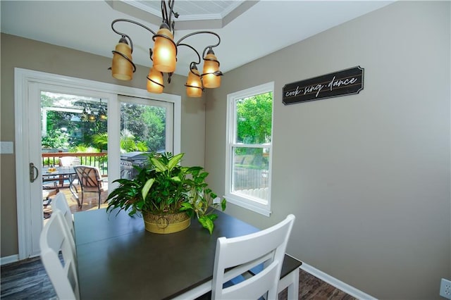 1005 Hunters Rd, Blue Springs, MO 64014 - dining area with a chandelier, dark wood finished floors, and a tray ceiling