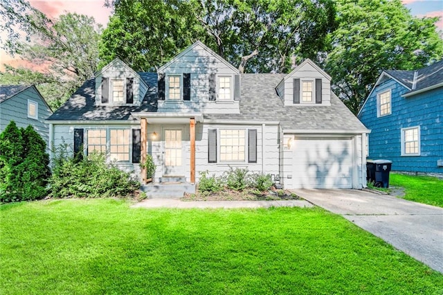 7712 Mcgee St, Kansas City, MO 64114 - cape cod house with a front lawn, concrete driveway, an attached garage, and roof with shingles