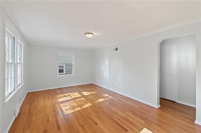 7712 Mcgee St, Kansas City, MO 64114 - unfurnished room featuring plenty of natural light, light wood-type flooring, crown molding, and arched walkways