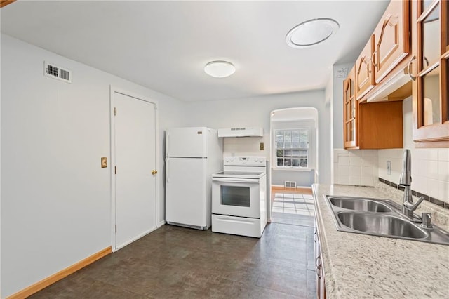 7712 Mcgee St, Kansas City, MO 64114 - kitchen with white appliances, exhaust hood, backsplash, light countertops, and glass insert cabinets