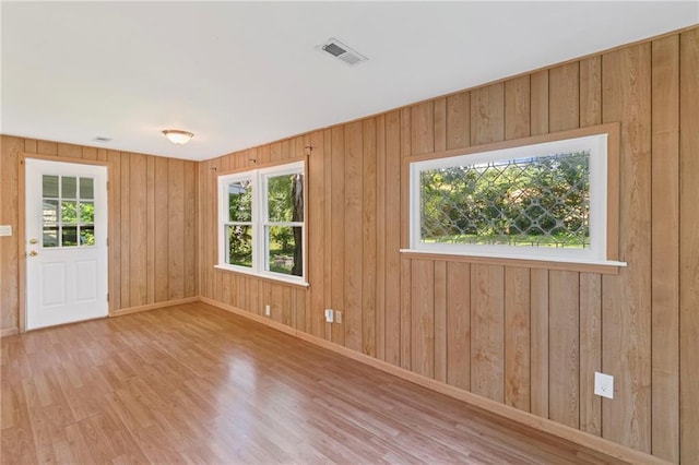 7712 Mcgee St, Kansas City, MO 64114 - unfurnished room featuring plenty of natural light and wood finished floors