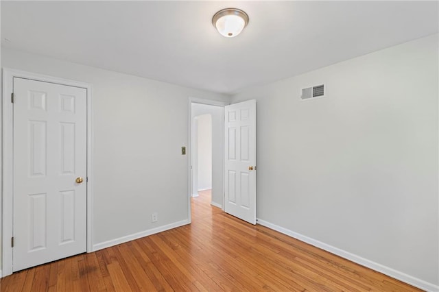 7712 Mcgee St, Kansas City, MO 64114 - unfurnished bedroom with baseboards and light wood finished floors