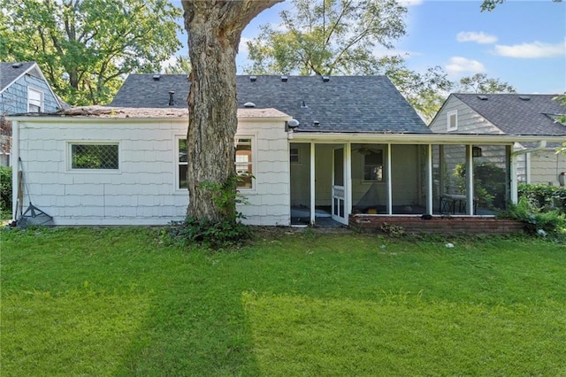7712 Mcgee St, Kansas City, MO 64114 - back of house with a yard, a sunroom, and roof with shingles