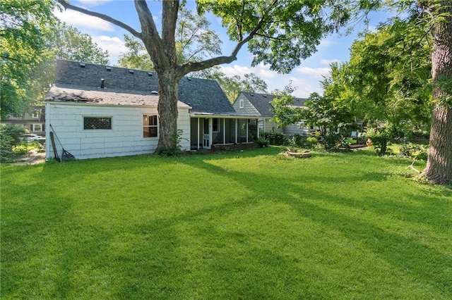 7712 Mcgee St, Kansas City, MO 64114 - rear view of house featuring a yard and a sunroom
