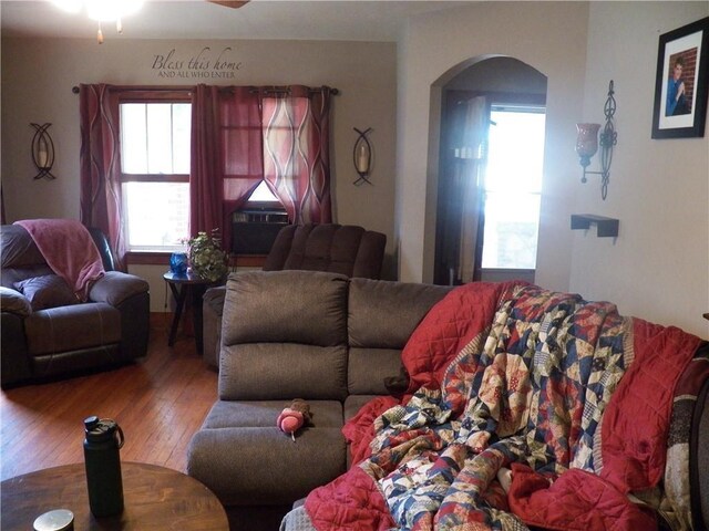 514 Front St, Prescott, KS 66767 - living area featuring arched walkways, wood finished floors, and a ceiling fan