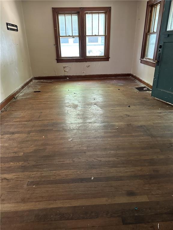 1906 S Willow Ave, Independence, MO 64052 - empty room featuring healthy amount of natural light and dark wood-type flooring