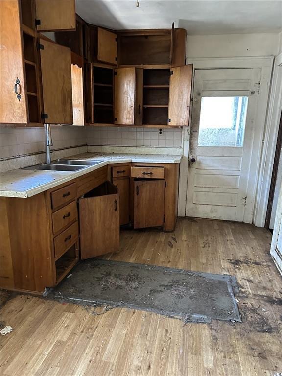 1906 S Willow Ave, Independence, MO 64052 - kitchen featuring open shelves, light wood-style floors, backsplash, and light countertops
