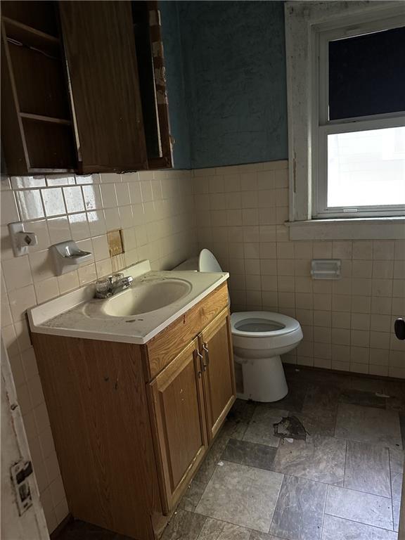 1906 S Willow Ave, Independence, MO 64052 - bathroom with tile walls and vanity