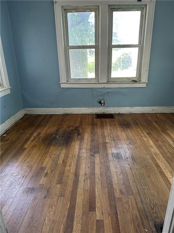 1906 S Willow Ave, Independence, MO 64052 - spare room with dark wood-type flooring and baseboards