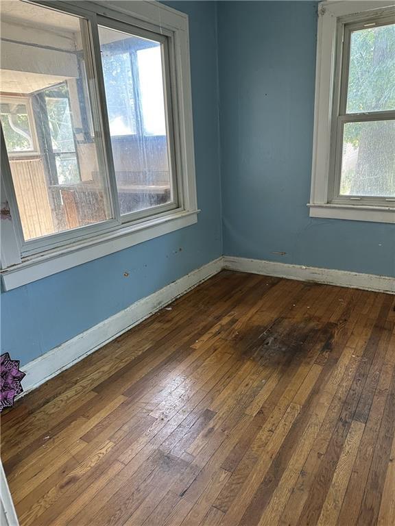 1906 S Willow Ave, Independence, MO 64052 - unfurnished room featuring dark wood-style floors and baseboards