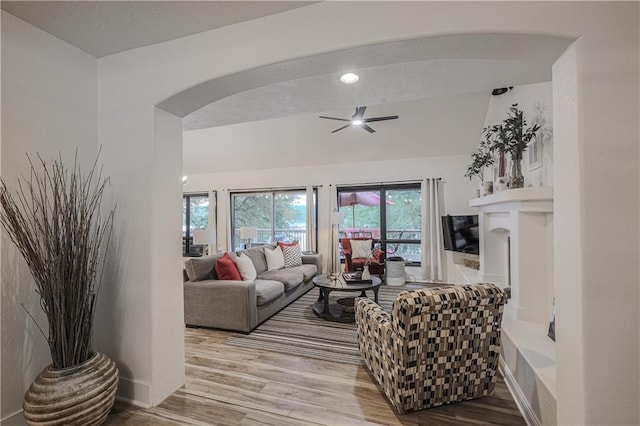 792 195th St, Fort Scott, KS 66701 - living area featuring wood finished floors, ceiling fan, arched walkways, and healthy amount of natural light