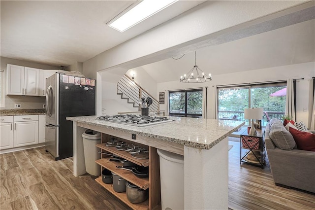 792 195th St, Fort Scott, KS 66701 - kitchen with appliances with stainless steel finishes, open shelves, plenty of natural light, and light wood finished floors