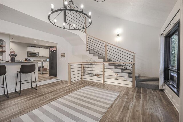 792 195th St, Fort Scott, KS 66701 - entryway with wood finished floors, a chandelier, and stairs