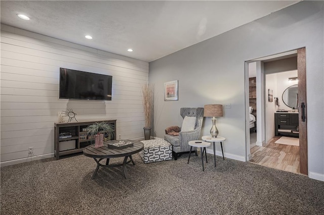 792 195th St, Fort Scott, KS 66701 - living area with carpet flooring, recessed lighting, and wood walls