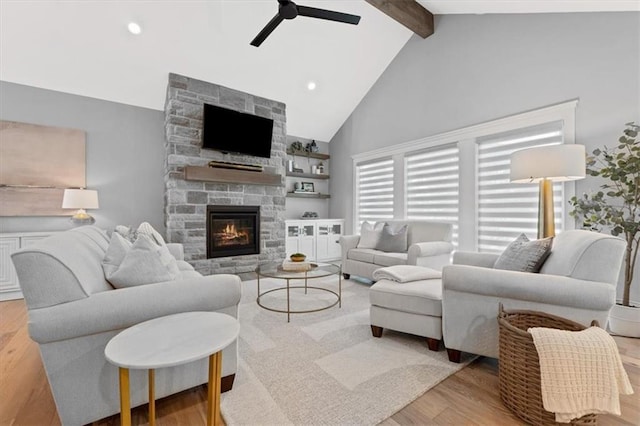 13 Tahoma Rdg, Lake Winnebago, MO 64034 - living room with ceiling fan, beamed ceiling, light wood-style flooring, a stone fireplace, and high vaulted ceiling