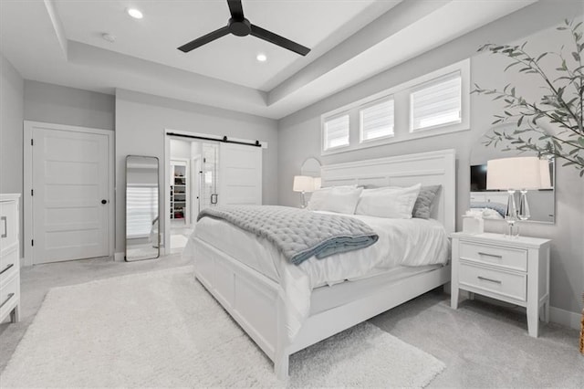 13 Tahoma Rdg, Lake Winnebago, MO 64034 - bedroom with a barn door, light carpet, recessed lighting, and a raised ceiling