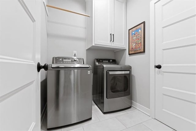 13 Tahoma Rdg, Lake Winnebago, MO 64034 - laundry area with cabinet space, washer and clothes dryer, and light tile patterned floors