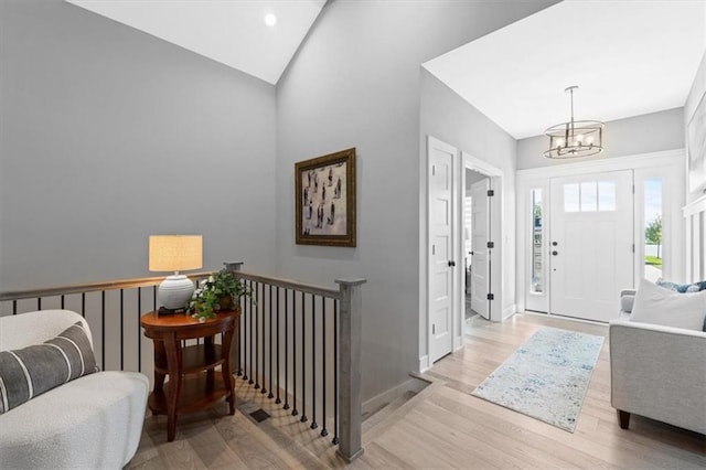 13 Tahoma Rdg, Lake Winnebago, MO 64034 - entryway with a chandelier, wood finished floors, vaulted ceiling, and recessed lighting