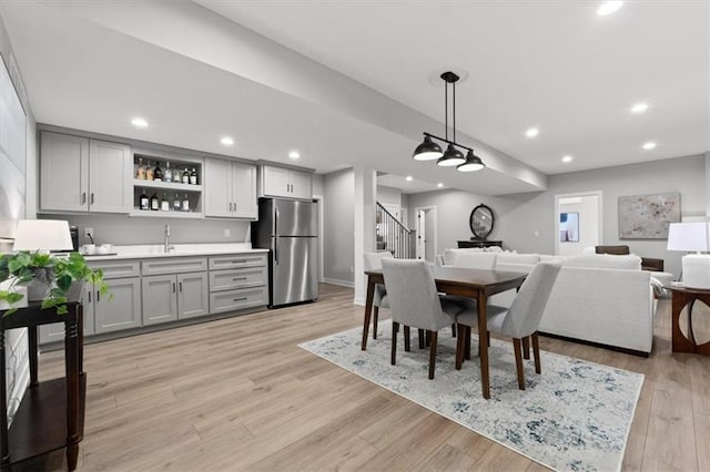 13 Tahoma Rdg, Lake Winnebago, MO 64034 - dining area featuring bar with sink, stairs, light wood-type flooring, and recessed lighting