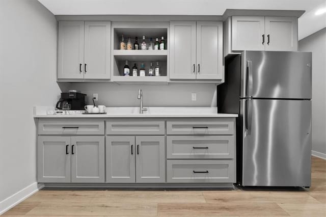 13 Tahoma Rdg, Lake Winnebago, MO 64034 - kitchen featuring freestanding refrigerator, gray cabinetry, light countertops, and open shelves