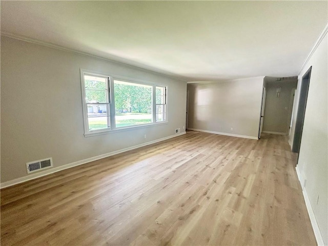 13006 Byars Rd, Grandview, MO 64030 - spare room featuring crown molding and light wood-type flooring