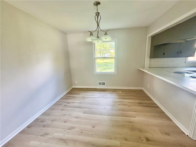 13006 Byars Rd, Grandview, MO 64030 - unfurnished dining area featuring light wood-type flooring