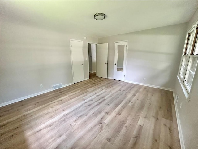 13006 Byars Rd, Grandview, MO 64030 - unfurnished bedroom featuring baseboards and wood finished floors